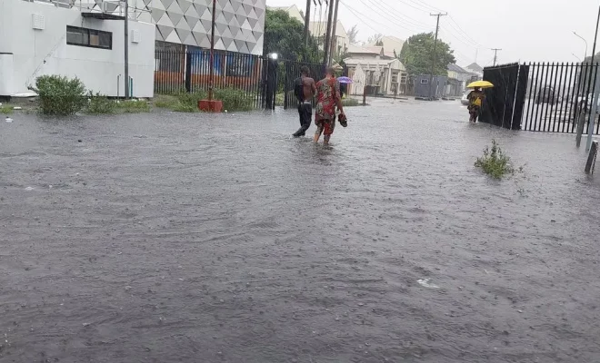 Boy swims in flooded road